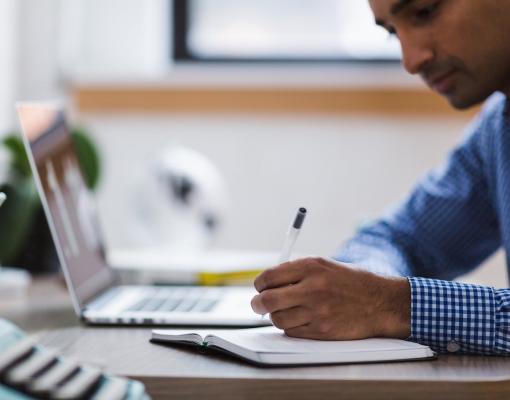 Man writing in notebook