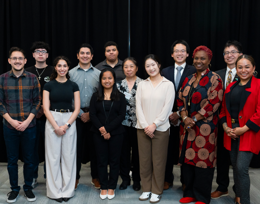 Students, alumni, faculty pose for a picture at Meet the Firms Night.