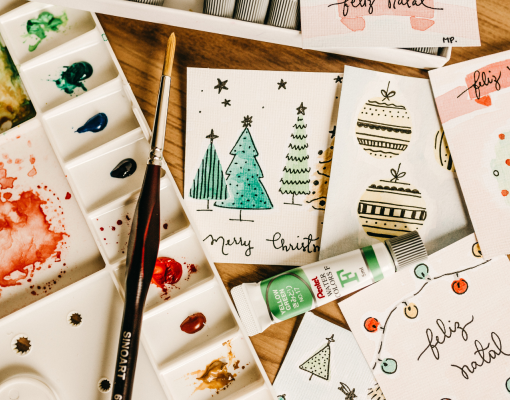 Arts and crafts supplies on top of holiday cards