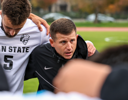 John Powell speaks to his players in the huddle.