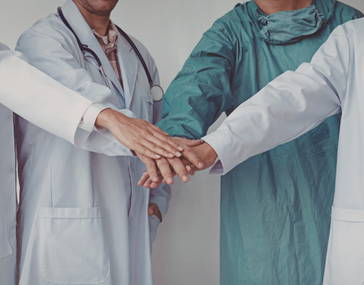 Healthcare workers putting their hands together