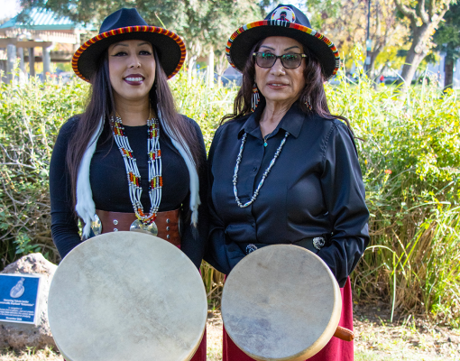 Two members of Sacred Rising Voices drumming circle