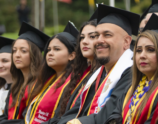 Graduates in academic regalia at Commencement