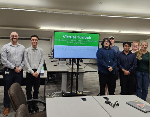Students and staff with city partners standing together in a computer lab