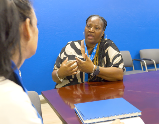 Two people sitting at a table talking