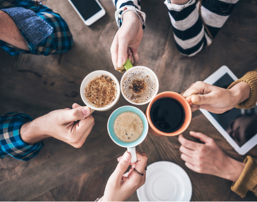 People cheering their coffees together