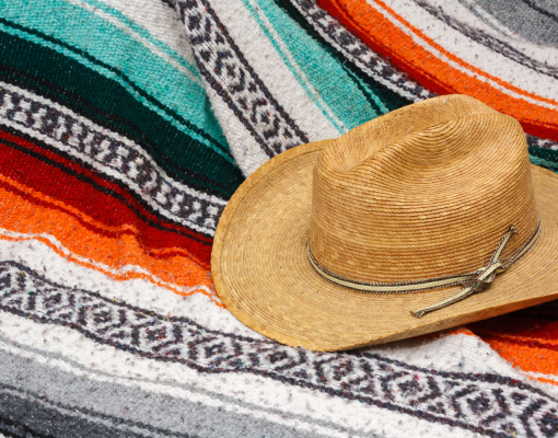 Traditional mexican blanket with hat on top