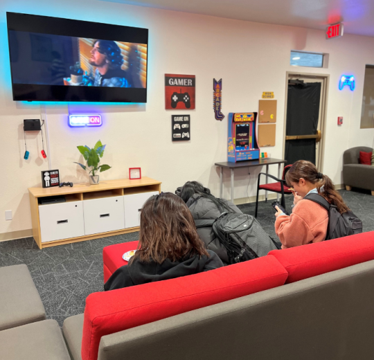 students in front of tv in game room