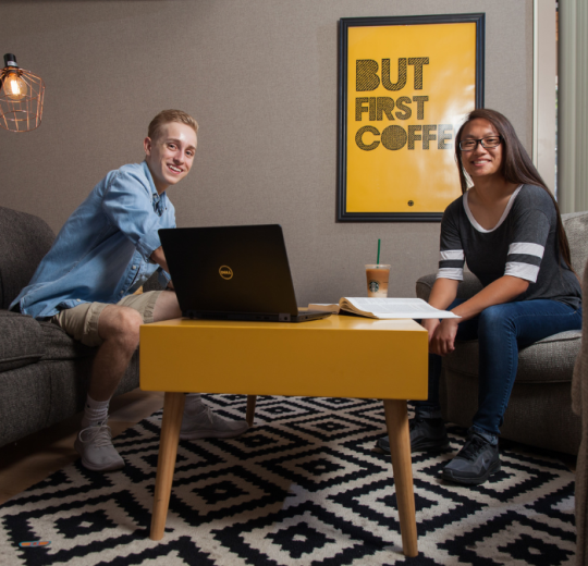 male and female student studying on laptop