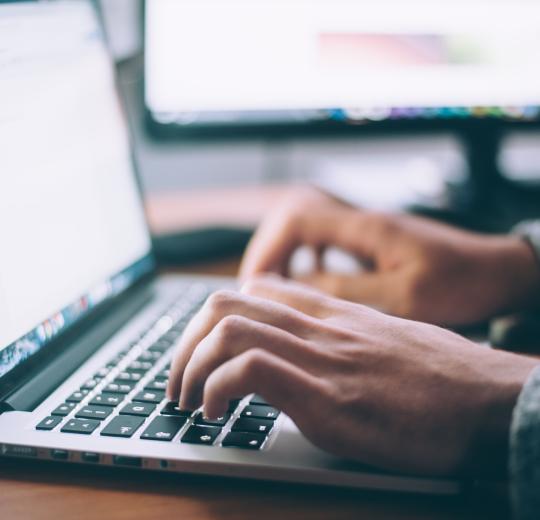 person typing on laptop