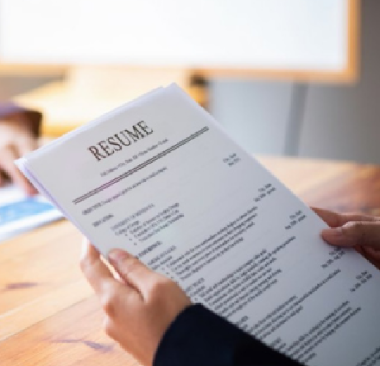 A person holds a resume.