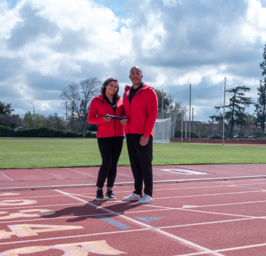 Two people standing on a track