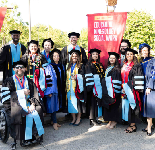 Ed.D. cohort pose for a photo at commencement.