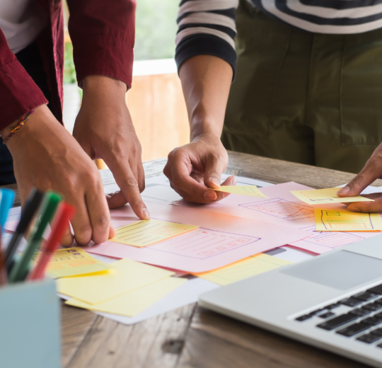 People at a desk working on a project