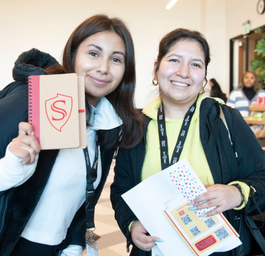 Two female students posing in Stan swag