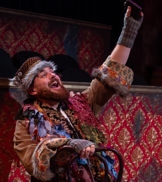 A male actor from the comet musical production is seen on stage