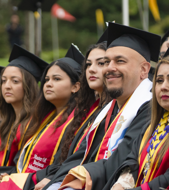 Graduates in academic regalia at Commencement