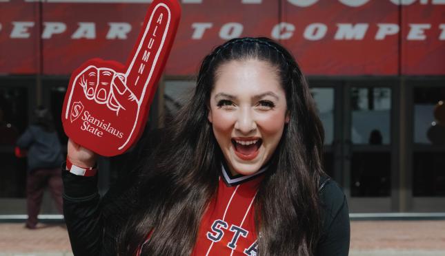 student celebrating outside athletics Fitzpatrick Arena
