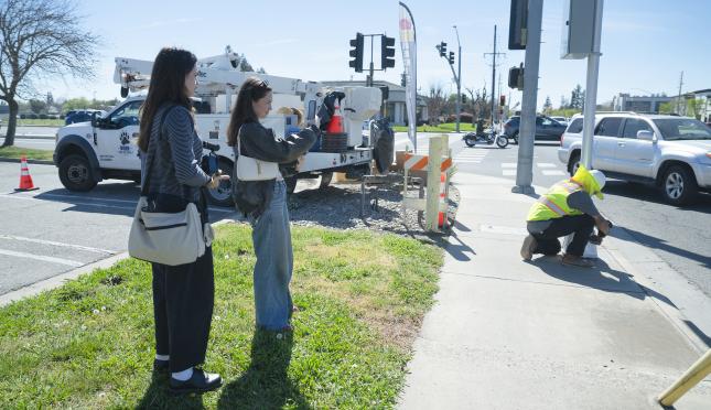 students covering newly activated red-light camera in Modesto
