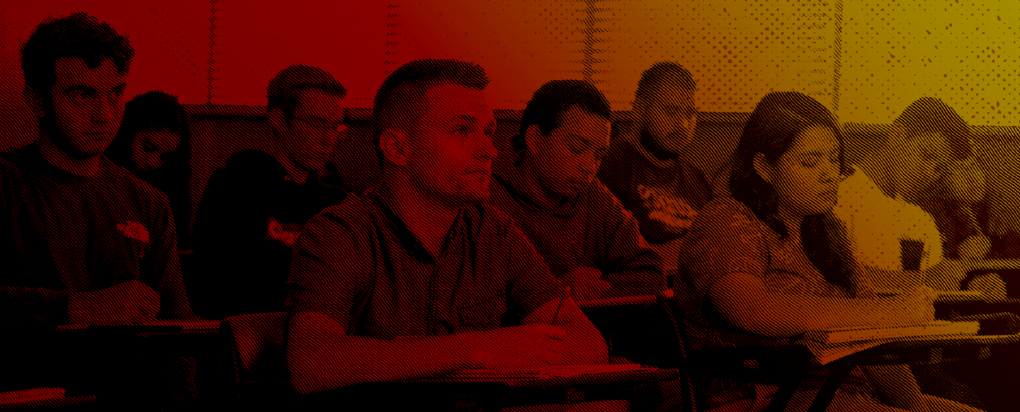 Duotone image of students inside a classroom.
